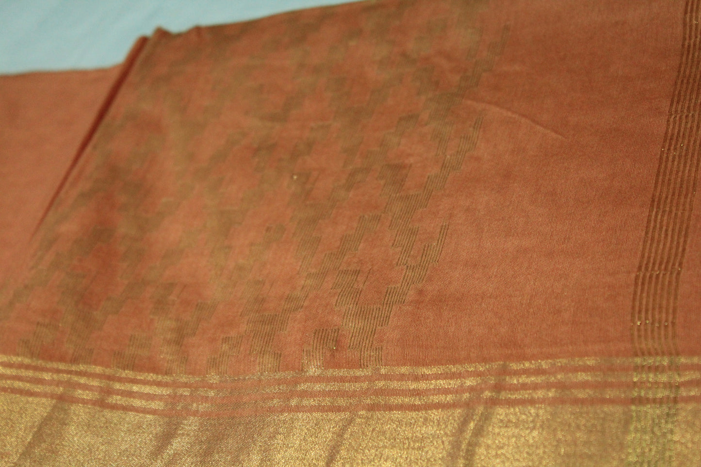 Embroided saree with golden zari border in orange color