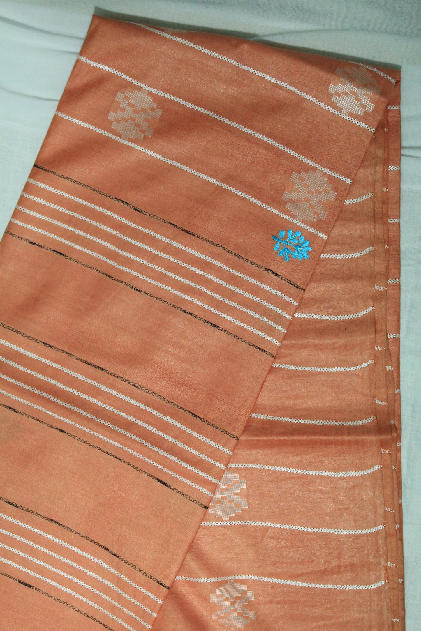 embroidered orange color saree with white pattern