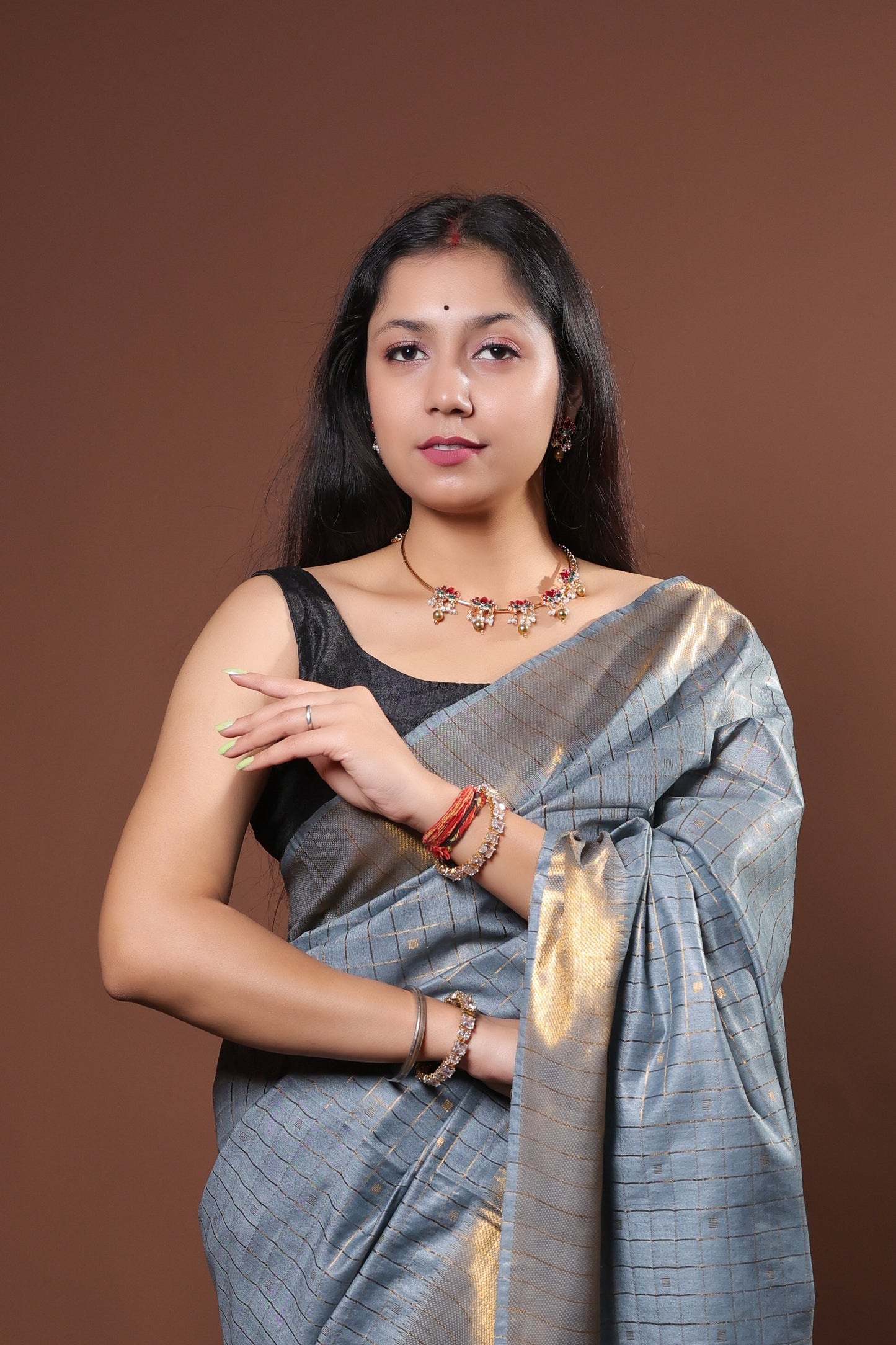 gray and gold saree with a solid  golder zari pattern on border and pallu