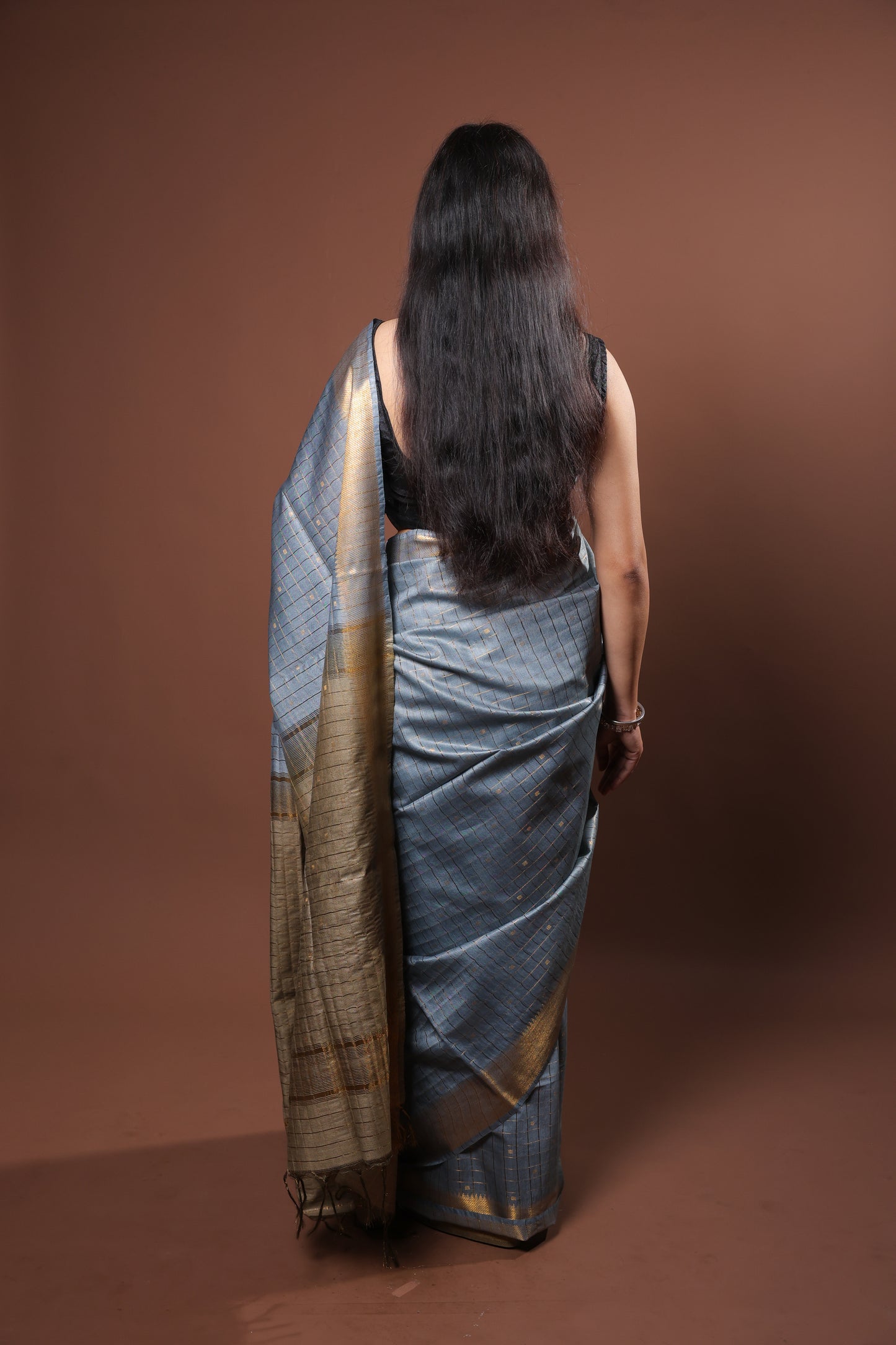 gray and gold saree with a solid  golder zari pattern on border and pallu