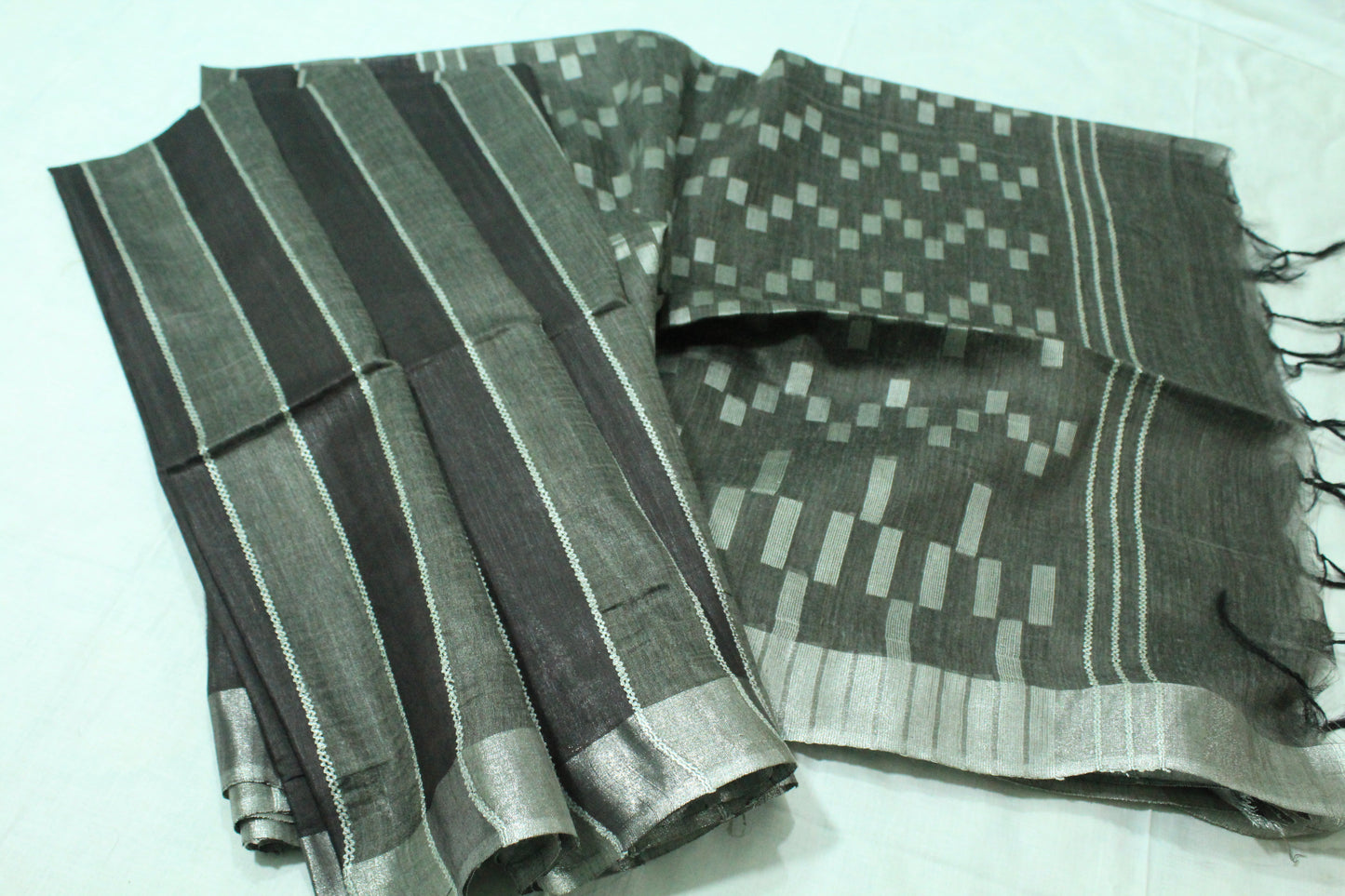 Staple body silver border black color silk Saree