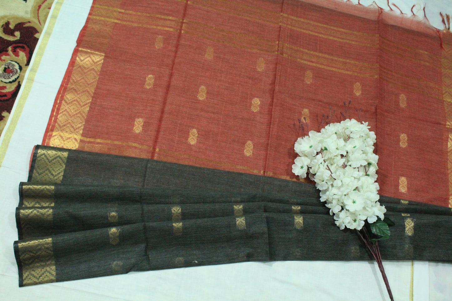 Golden zari buta border silk festive wear black and red color Saree