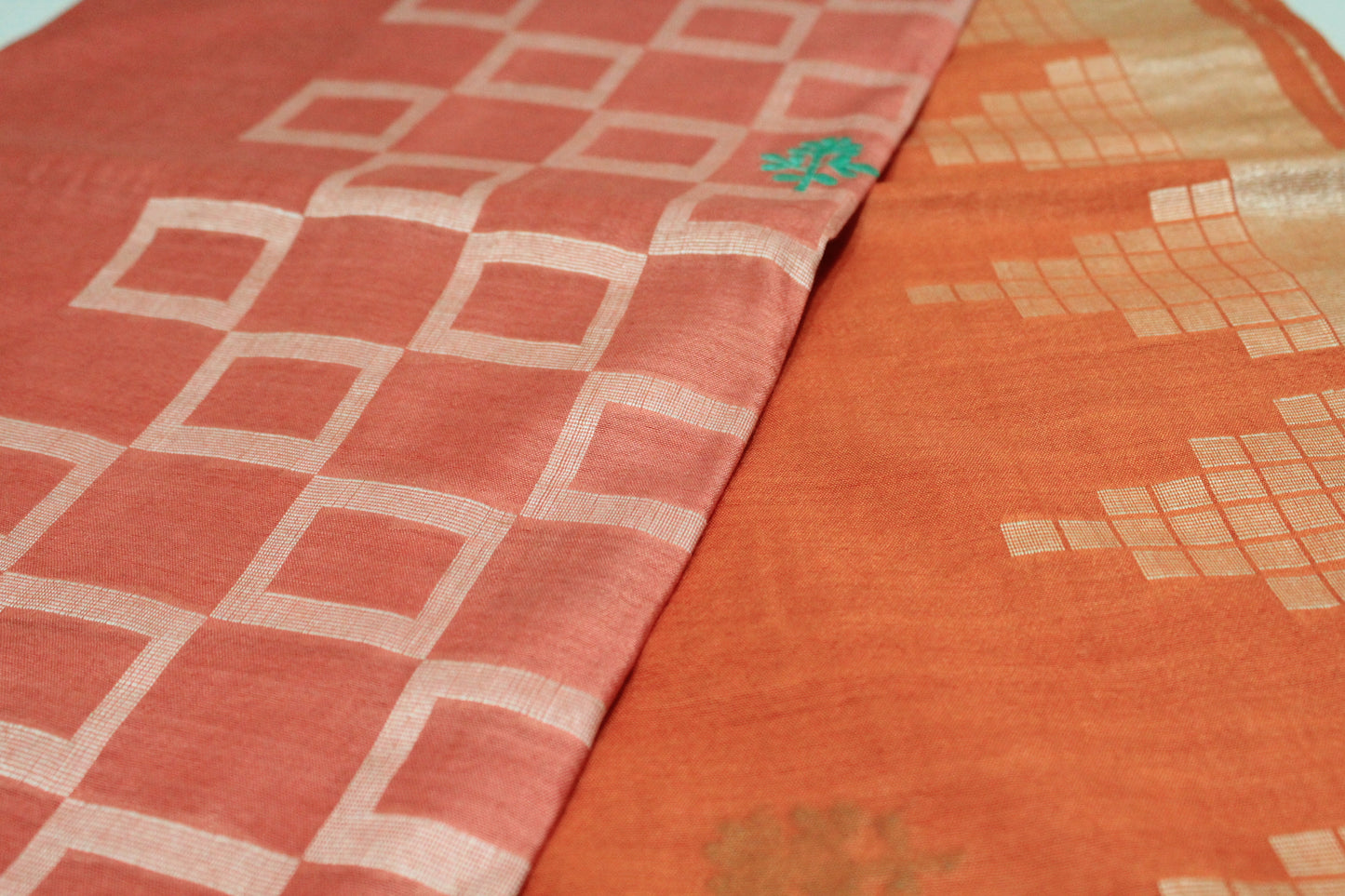 Embroidered festive orange and pink saree with zari work