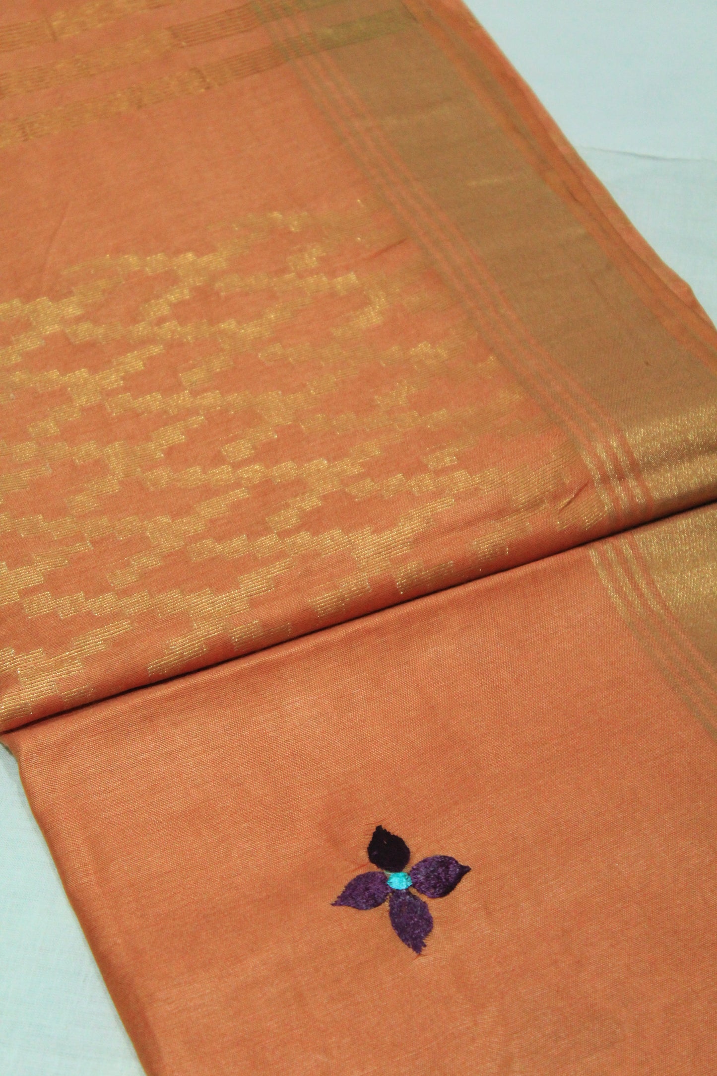 Embroided saree with golden zari border in orange color